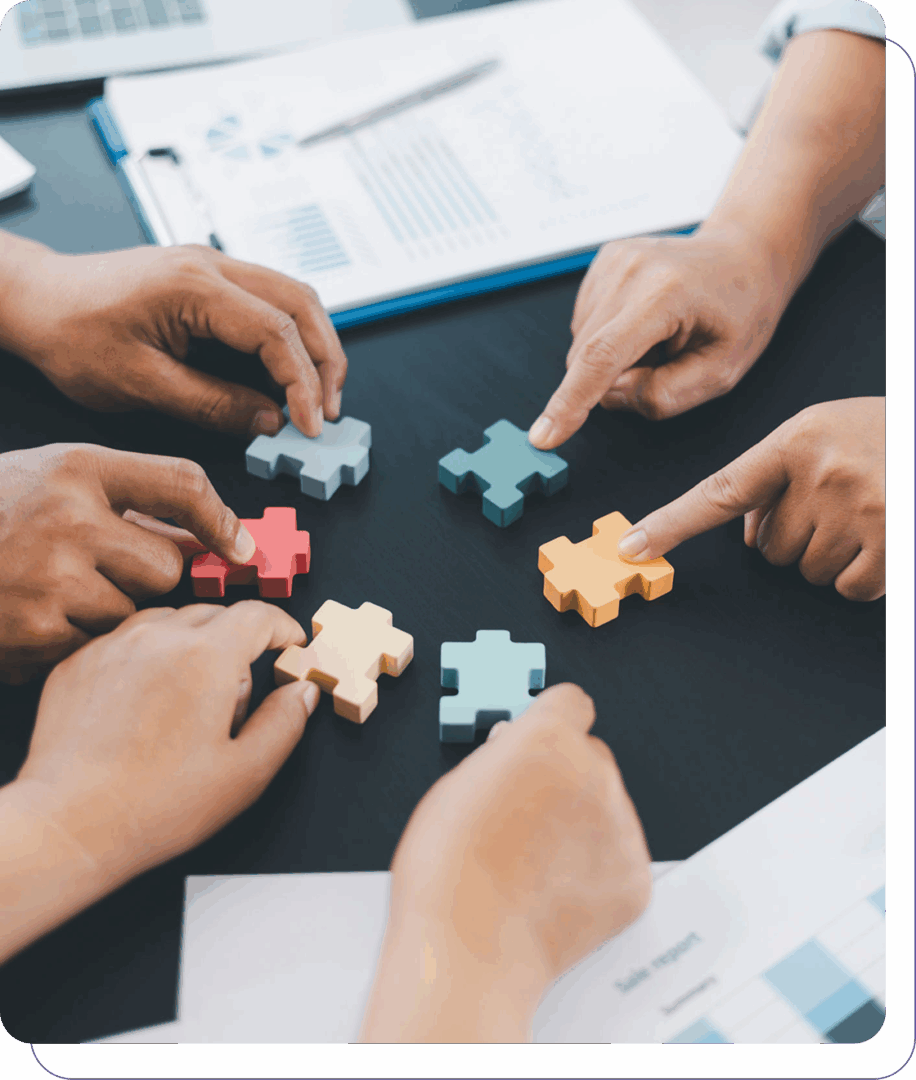 Hands assembling colorful puzzle pieces together.