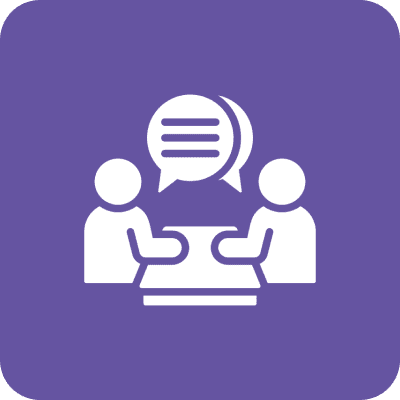 Two people talking at a table icon.